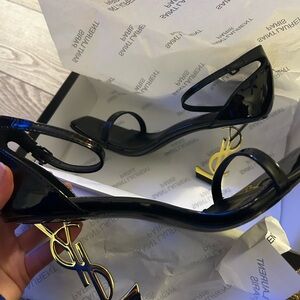 Saint Laurent Glossy Black Heels with Gold Accent